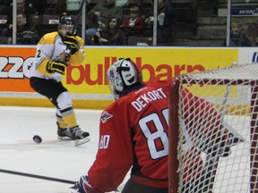 Spits goalie Jordan DeKort, right, makes a save on Sarnia's Charlie Sarault Friday in Sarnia. (Special to The Star)
