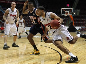 Windsor's Anthony Johnson, right, drives to the basket at the WFCU Centre. (DAX MELMER/The Windsor Star)