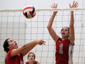 Brennan's Mandy Johnstone, right, attempts to block a return from Holy Names' Carly Steer during the high school senior girls volleyball game at Holy Names. (JASON KRYK/The Windsor Star)