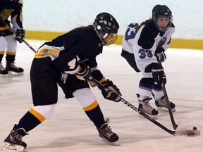 St. Joseph's Leigha Mazoric, left, steals the puck from Villanova's Kristie Matte Wednesday during girls high school hockey at the Vollmer Centre. (NICK BRANCACCIO/The Windsor Star)