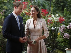 St James’s Palace has announced that Prince William and Catherine Duchess Of Cambridge are expecting a baby. The two share a smile as they look at an orchid named in honour of Diana, Princess of Wales at Singapore Botanical Gardens in this 2012 file photo. (Photo by Danny Lawson - Pool/Getty Images)