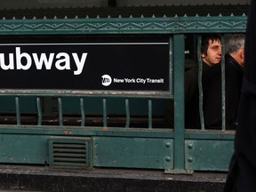 People exit a subway stop in Manhattan two days after a man was pushed to his death in front of a train on December 5, 2012 in New York City. The incident was caught by a photographer and has since raised questions as to why someone didn't help the man before the train struck him. (Spencer Platt/Getty Images)