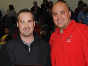 LaSalle's Eric Cassidy, left, receives a hall of fame plaque from Concordia associate athletic director Kyle Rayl. (Courtesy of Concordia University)