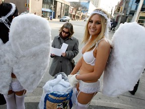 Angels Emily Lavender and Brandi Dugal, right, of PETA of set up their clouds and ask Windsor area residents and visitors to leave furs, wool, leather and exotic skins off their shopping lists this holiday season, Friday December 14, 2012. Media members, centre,  were on hand interview the angels. (NICK BRANCACCIO/The Windsor Star)