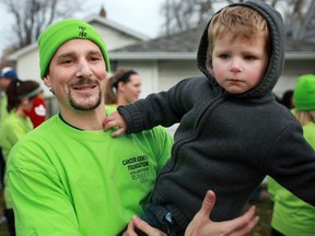 Brad Byrne, son of Joe Byrne who passed away from cancer in 2008, holds his son, Liam Byrne, in this 2011 file photo. (DAX MELMER/The Windsor Star)