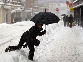 A pedestrian jumps over snow in downtown Zagreb, Croatia,  Saturday, Dec. 8, 2012. Parts of eastern and central Europe were hit hard by heavy snow and freezing temperatures. (AP Photo/Darko Bandic)