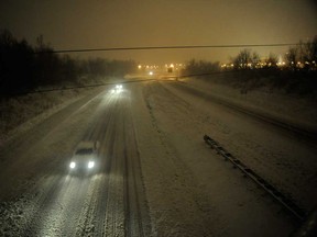 Motorists travel slowly on a snow-covered Interstate 24 during a winter storm Wednesday, Dec. 26, 2012, in Paducah, Ky. The storm dumped several inches of snow making travel hazardous. (AP Photo/Stephen Lance Dennee)