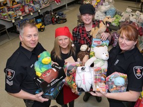 The Windsor Police made a sizeable donation of toys to the Windsor-Essex Children's Aid Society on Wednesday, Dec. 12, 2012, in Windsor, Ont. Sgt. Andrew Moxley, from left, Tina Gatt and Andrea Madden of the CAS and Const. Holly Burt pose with some of the toys. (DAN JANISSE/The Windsor Star)
