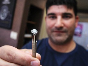 A diamond similar to one allegedly swallowed by a wanted thief thursday, is held by Precision Jewellers co-owner, Dan Thomas  Saturday, May 12, 2012.  (DAX MELMER/The Windsor Star)