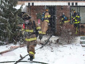 Windsor firefighters tend to a house fire at 3590 Girardot St. in West Windsor, Wednesday, Dec. 26, 2012.  There were no reported injuries.  (DAX MELMER/The Windsor Star)