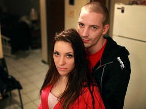 Melissa Decarie, 23, left, and her boyfriend, Charles Johnson, 22, pictured at Johnson's parents apartment, Wednesday, Dec. 26, 2012, lost everything in a fire at their previous apartment.  (DAX MELMER/The Windsor Star)
