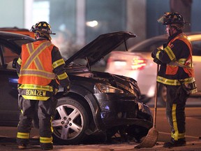 Firefighters tend to a two vehicle collision Saturday, December 22, 2012 on Ouellette Avenue and Shepherd Street. (KRISTIE PEARCE/ The Windsor Star)