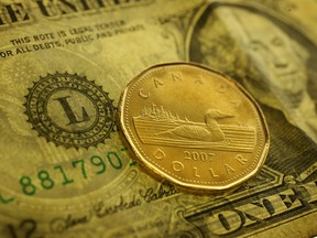 A loonie and an American dollar are seen in this file photo. (Tyler Brownbridge/The Windsor Star)