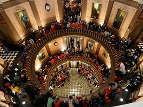 In this file photo, protesters gather for a rally in the State Capitol rotunda in Lansing, Mich., Tuesday, Dec. 11, 2012. The crowd is protesting right-to-work legislation passed last week. Michigan could become the 24th state with a right-to-work law next week. Rules required a five-day wait before the House and Senate vote on each other's bills; lawmakers are scheduled to reconvene Tuesday and Gov. Snyder has pledged to sign the bills into law. (AP Photo/Paul Sancya)