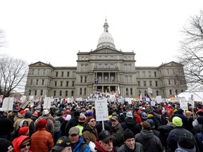 Protesters gather for a rally at the State Capitol in Lansing, Mich., Tuesday, Dec. 11, 2012. The crowd is protesting right-to-work legislation passed last week. Michigan could become the 24th state with a right-to-work law next week. Rules required a five-day wait before the House and Senate vote on each other's bills; lawmakers are scheduled to reconvene Tuesday and Gov. Snyder has pledged to sign the bills into law. (AP Photo/Paul Sancya)