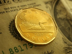 A loonie and an American dollar are seen in this file photo. (Tyler Brownbridge/The Windsor Star)