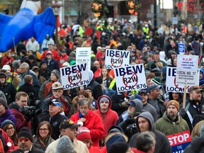 Thousands of protesters gather for a rally on the State Capitol grounds in Lansing, Mich., Tuesday, Dec. 11, 2012. (AP Photo/Carlos Osorio)