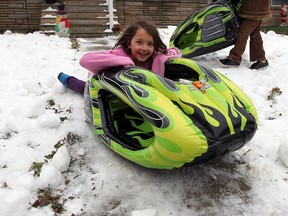 Chloe Patrick, 7, enjoys a snowy afternoon at the home of Mike Evans, who might be the only person in Essex County prepared for a white Christmas.  Evans has covered his whole front yard with snow, taken from a local arena Monday, December 24, 2012. (NICK BRANCACCIO/The Windsor Star)