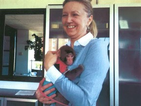 Yasmi Nakhuda is shown with her pet Rhesus macaque Darwin in this court photo released on Saturday Dec. 15, 2012. The owner of a monkey who was found in a Toronto Ikea parking lot last weekend wearing a shearling coat is going to court to get him back. (The Canadian Press)