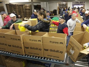 The Windsor Goodfellows were busy Wednesday, Dec. 12, 2012, packing some of the 6,000 Christmas boxes that will donated over the holiday season. A small army of volunteers spent most of the day preparing the packages.  (DAN JANISSE/The Windsor Star)