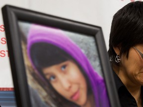 A photograph of Summer "CJ" Morningstar Fowler, of the Gitanmaax First Nation near Hazelton, B.C., is displayed as her mother Matilda Fowler weeps during a news conference in Vancouver, B.C., on Wednesday December 12, 2012.  (The Canadian Press/Darryl Dyck)