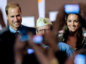 In this July 10, 2011, file photo, Prince William and wife Kate, the Duke and Duchess of Cambridge, are photographed by fans during a visit to the U.S. in Culver City, Calif. (AP Photo/Chris Pizzello)