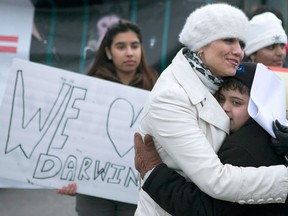 Yasmin Nakhuda (left) hugs her twelve year old son Misha outside an Animal Services offices in Toronto on Wednesday December 19, 2012 as she rallies support for the return of her monkey which was seized earlier this month after it was found wandering at an Ikea parking lot. THE CANADIAN PRESS/Chris Young