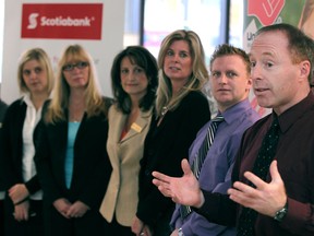 Joseph Picard, director of education at the French Catholic School Board, right, thanks Scotiabank employees and members of the United Way at a Shoes for Schools announcement at the Scotiabank main branch in downtown Windsor, Wednesday, Dec. 19, 2012.  Shoes for Schools raised money to the sum of $7,100 through donations from Scotiabank clients and staff which amounted to 394 pairs of shoes to be given to children among the three local school boards.  (DAX MELMER/The Windsor Star)