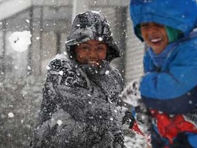 Alex Biru, 10, left, throws a snowball at his younger brother, Abel Biru, 4, while they enjoy the snow in their front yard on the 500 block of Cameron Avenue in Windsor, Ont, Wednesday, Dec. 26, 2012.  (DAX MELMER/The Windsor Star)