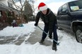 Guy Joly shovels the sidewalk in front of his home in Windsor, Ont. on Thursday, December 27, 2012. Windsor was hit with close to 15 cm of snow Wednesday as a storm passed through the region.         (JASON PRUPAS/ Special to The Star)