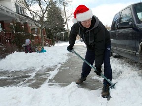 Guy Joly shovels the sidewalk in front of his home in Windsor, Ont. on Thursday, December 27, 2012. Windsor was hit with close to 15 cm of snow Wednesday as a storm passed through the region.         (JASON PRUPAS/ Special to The Star)