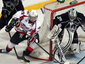 Windsor's Ben Johnson, centre, is stopped by Plymouth goalie Alex Nedeljkovic, right, and defenceman Colin MacDonald at the WFCU Centre Monday. (Nick Brancaccio/The Windsor Star)