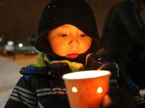 Lucas Gamez, 4, holds a candle at a vigil in memory of six year-old Ana Marquez-Greene, a victim of Friday's mass shooting in Newtown, Conn., on Monday December 17, 2012. The vigil was held at the University of Winnipeg, where Ana's mother had previously worked as a licensed therapist. THE CANADIAN PRESS/Trevor Hagan