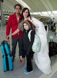 Krisztina Sebesi (centre) poses with her fiance Rex Lu and ten-year-old daughter Salena as they depart Pearson Airport in Toronto on Saturday December 8, 2012 for their Dec. 12 wedding in Aruba. As if getting engaged on New Year's Eve wasn't enough of a milestone, Krisztina Sebesi and Rex Lu are upping the ante with their choice of a once-in-a-century wedding date. They are set to exchange vows during a sunset ceremony in Aruba on Wednesday, Dec. 12, 2012 - or 12-12-12. THE CANADIAN PRESS/Frank Gunn