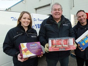 Lynsey Millman, Marty Gillis and Marty Komsa (left to right), from WFCU, drop of a load of food at the Society of St. Vincent De Paul in Windsor on Thursday, December 6, 2012. They also made 3 other stops across the city dropping of food items.             (TYLER BROWNBRIDGE / The Windsor Star)