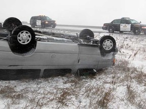 OPP on the scene of a rollover on Hwy 401 near Lakeshore Road 123, Wednesday December 26, 2012.  OPP and Essex-Windsor EMS paramedics responded to the scene where a Ford E-350 passenger van lost control and overturned in the westbound ditch.  (NICK BRANCACCIO/The Windsor Star)