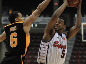Windsor Express guard Victor Morris, right, shoots over London Lightning forward Adrian Moss during NBL of Canada action at the WFCU Centre Friday. (JASON KRYK/The Windsor Star)