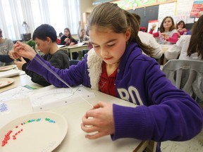 Morgan Pake joins her classmates as they make rosaries at St. John the Evangelist school in Woodslee on January 21, 2010. The Rosaries are being sold by students to raise money for Haiti.          (TYLER BROWNBRIDGE / The Windsor Star)