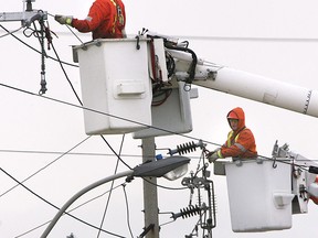 Files: Enwin Utility technicians work on a powerlines along the Ojibway Parkway in 2007. (Windsor Star files)
