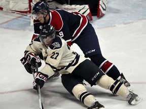 Windsor's Saverio Posa, front, is checked by Saginaw's Justin Kea at the WFCU Centre, (NICK BRANCACCIO/The Windsor Star)