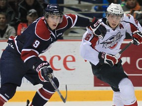 Saginaw's Justin Kea, left, checks Windsor's Kerby Rychel at the WFCU Centre this year.  (DAN JANISSE/The Windsor Star)