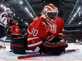 Team Canada goalie Malcolm Subban lays on the ice after making a save as Team USA forward Rocco Grimaldi, left, skates by at the World Junior Championships in Ufa, Russia. (The Canadian Press//Mark Blinch)