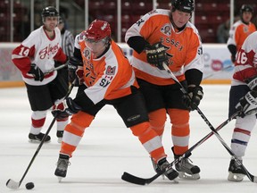 Spits GM Warren Rychel, centre, handles the puck during the Essex 73's Alumni Classic against the Leamington Flyers Alumni at Essex Arena Sunday,  (DAX MELMER/The Windsor Star)