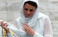 Britain's Prince William's wife Catherine, the Duchess of Cambridge adjusts her scarf outside a mosque at KLCC in Kuala Lumpur in this September 2012 file photo. (SAEED KHAN/AFP/Getty Images)