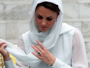 Britain's Prince William's wife Catherine, the Duchess of Cambridge adjusts her scarf outside a mosque at KLCC in Kuala Lumpur in this September 2012 file photo. (SAEED KHAN/AFP/Getty Images)