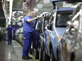 Employees working on a car assembly line producing the Fiat Panda in Tychy, Poland in 2009. Italian auto giant Fiat is cutting 1,500 staff in Poland, it said on December 7, 2012, meaning one third of of its workers in the country will lose their jobs. (Bartek Wrzeniowski/ AFP Getty)