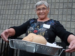 Alice Bieber holds her PanPartner, a cooking tool she invented that helps sturdy foil pans in the oven.  (DAX MELMER/The Windsor Star)
