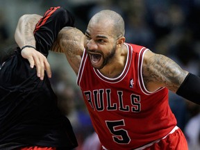 Chicago Bulls forward Carlos Boozer (5) celebrates with guard Nate Robinson after dunking the ball against the Detroit Pistons in the fourth quarter of an NBA basketball game Friday, Dec. 7, 2012, in Auburn Hills, Mich. Boozer scored 24 points in a 108-104 win. (AP Photo/Duane Burleson)