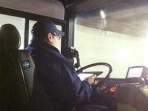 A Transit Windsor bus driver is pictured using his iPad in this handout photo. (HANDOUT Deadline Detroit/The Windsor Star)
