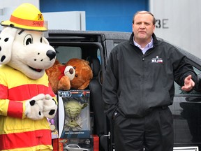 For a tenth straight year, Chrysler Canada's Windsor Assembly Plant employees participated in the city's largest toy drive. Several minivans full of new toys valued at over $15,000 were donated to Sparky's Toy Drive on Friday, Dec. 7, 2012, at the plant in Windsor, Ont. The toys will  benefit local needy children with gifts during the holiday season. Dan Omahen, Plant Manager, Windsor Assembly, speaks during the event with the Windsor Fire and Rescue mascot Sparky by his side. (DAN JANISSE/The Windsor Star)